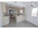 Eat-in kitchen with ample counter space, tile floors and modern appliances at 1349 Goldenglow Rd, Las Vegas, NV 89108