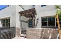 Home entrance featuring a covered walkway, a teal front door and modern architecture at 1485 Melodic Lark Ln, Las Vegas, NV 89138