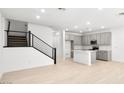 Open-concept kitchen featuring an island, stainless steel appliances, and modern gray cabinetry at 1485 Melodic Lark Ln, Las Vegas, NV 89138