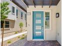 The attractive blue front door features glass panels and opens onto a brick paver landing and gravel walkway at 1491 Melodic Lark Dr, Las Vegas, NV 89138