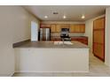 Bright kitchen featuring a large island, stainless steel appliances, and ample cabinet space at 2132 Tierra Del Verde St, Las Vegas, NV 89156
