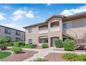 Charming exterior with neutral stucco, private balconies, covered entry, and manicured landscaping, creating a welcoming atmosphere at 2305 W Horizon Ridge Pkwy # 611, Henderson, NV 89052