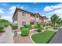 Well maintained exterior featuring lush landscaping, pet waste station, and convenient sidewalk access, offering a welcoming community vibe at 2305 W Horizon Ridge Pkwy # 611, Henderson, NV 89052