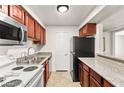 Functional kitchen featuring granite countertops, wood cabinets, and stainless-steel appliances at 2606 S Durango Dr # 276, Las Vegas, NV 89117