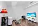 Bright living room with modern furnishings, wood floors, and a large television for entertainment at 2851 S Valley View Blvd # 1120, Las Vegas, NV 89102