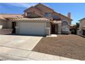 Well-kept two-story home with a two-car garage, mature landscaping, and inviting entrance at 3238 Canyon Terrace Dr, Laughlin, NV 89029