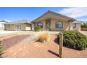 Beautiful single-story home with landscaped yard, desert landscape, and covered porch in front of the house at 3241 E Winery Rd, Pahrump, NV 89048