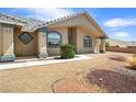 A charming home featuring lovely windows framed in blue for a great curb appeal at 3241 E Winery Rd, Pahrump, NV 89048