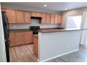 Well-equipped kitchen featuring wooden cabinetry, modern appliances, and a breakfast bar at 3617 Austell St, Las Vegas, NV 89129