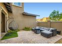 Relaxing outdoor patio with stylish furniture and a cozy hanging chair at 391 Capistrano Vistas St, Las Vegas, NV 89138
