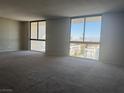 Spacious living room featuring large windows that let in plenty of natural light at 3930 University Center Dr # 901, Las Vegas, NV 89119