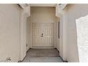 Inviting entryway features double doors and a covered porch, offering a warm welcome to the home at 4029 Ricebird Way, North Las Vegas, NV 89084