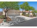 Charming single-story home with a tile roof, mature trees, and a spacious three-car garage at 4029 Ricebird Way, North Las Vegas, NV 89084