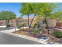 Charming single-story home with a tile roof, mature trees, and a well-maintained front yard at 4029 Ricebird Way, North Las Vegas, NV 89084