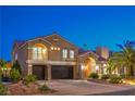 Elegant two-story home featuring a three-car garage, arched entry, stone accents, and lush landscaping at 4045 Abernethy Forest Pl, Las Vegas, NV 89141