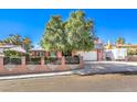 Exterior view of home with desert landscaping and a two-car garage at 4095 Ridgewood Ave, Las Vegas, NV 89120
