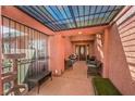 Inviting front porch with seating, decorative ironwork, and a stylish front door at 4095 Ridgewood Ave, Las Vegas, NV 89120