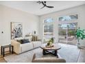 Bright living room with a modern design, neutral colors, and access to the backyard at 4314 Livorno Ave, Las Vegas, NV 89141