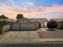 Inviting single story home with mature landscaping, three car garage, and tile roof at 4323 Pageantry Falls Dr, North Las Vegas, NV 89031