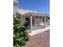 Back patio with pergola creates shade and outdoor living, accessed by sliding glass doors at 4323 Pageantry Falls Dr, North Las Vegas, NV 89031