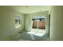 Bright bedroom featuring sliding glass doors to the backyard, offering natural light at 4684 Parkarbor Ave, Las Vegas, NV 89141