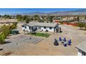 Expansive backyard on a home featuring a fire pit, hammock and space for activities, against a mountain backdrop at 4981 E Pawnee Pl, Pahrump, NV 89061