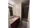 Well-lit bathroom featuring a granite vanity, framed mirror, and shower-tub combo at 5251 Indian River Dr # 271, Las Vegas, NV 89103