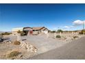 This beautiful property includes a covered carport, desert landscaping, and mountain views at 5950 Mojave St, Pahrump, NV 89061