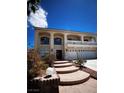 Front exterior of a two-story home with steps leading to the front door and a well manicured yard at 6571 Abalone Shell Ct, Las Vegas, NV 89139