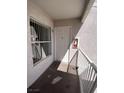 Exterior view of a condo entrance featuring a white front door, window, security features and a wall mounted fire extinguisher at 6800 E Lake Mead Blvd # 2024, Las Vegas, NV 89156