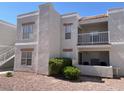 Condo exterior with multiple windows, a balcony, and a well-maintained, xeriscaped front yard with desert landscaping at 6800 E Lake Mead Blvd # 2024, Las Vegas, NV 89156