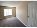 Inviting living room featuring neutral walls, modern carpet, and natural light streaming through window blinds at 6800 E Lake Mead Blvd # 2024, Las Vegas, NV 89156