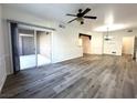 Bright living room featuring wood-look floors, ceiling fan and sliding doors to the patio at 6868 Sky Pointe Dr # 1118, Las Vegas, NV 89131