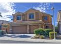 Two-story home showcasing a two-car garage, desert landscaping, and a secure decorative gate at 72 Broken Putter Way, Las Vegas, NV 89148