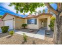 Inviting front exterior with desert landscaping, a tiled roof, and a covered porch entrance at 7547 Rolling River Dr, Las Vegas, NV 89131