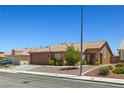Quaint single-story home featuring a two-car garage and easy-care desert landscaping at 7825 White Grass Ave, Las Vegas, NV 89131