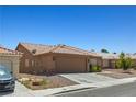 Quaint single-story home featuring a two-car garage and low-maintenance desert landscaping at 7825 White Grass Ave, Las Vegas, NV 89131