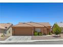 Charming single-story home with a well-maintained yard and a two-car garage at 7825 White Grass Ave, Las Vegas, NV 89131