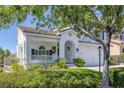 Beautiful two-story home featuring a welcoming front porch with lush, green landscaping at 7849 Meandering Light Ave, Las Vegas, NV 89131