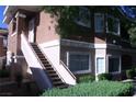 Two-story condo with stairs leading to the second level, featuring stucco siding and well-maintained landscaping at 830 Carnegie St # 1011, Henderson, NV 89052