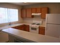 Bright kitchen with ample countertop space, wooden cabinets, and modern appliances including a gas range at 830 Carnegie St # 1011, Henderson, NV 89052