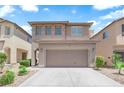 Two-story home featuring a two-car garage, neutral paint, and desert landscaping at 8562 Burning Bridge Ct, Las Vegas, NV 89131