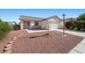 Single-story home with xeriscaping, a covered entryway, and attached two car garage at 905 Harp Way, North Las Vegas, NV 89032
