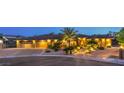Inviting home exterior with desert landscaping, paver driveway, and illuminated pathway at 9135 Hickam Ave, Las Vegas, NV 89129
