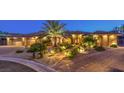 Inviting home exterior with desert landscaping, paver driveway, and illuminated pathway at 9135 Hickam Ave, Las Vegas, NV 89129