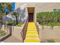 Inviting stairway leading to the front door, complemented by colorful landscaping and a well-maintained exterior at 9325 W Desert Inn Rd # 104, Las Vegas, NV 89117