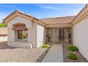 Inviting home entrance featuring a gated front porch and lush desert landscaping at 10413 Marymont Pl, Las Vegas, NV 89134