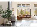 Bright living room with large windows, neutral color palette, and modern furnishings at 11015 Sanctuary Cove Ct, Las Vegas, NV 89135