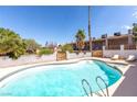 Sparkling pool with sun loungers surrounded by lush backyard landscaping at 120 W Highland Dr, Henderson, NV 89015
