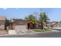 Well-maintained single-story home with manicured lawn, attached garage, and solar panels at 1310 Ripplestone Ave, North Las Vegas, NV 89081